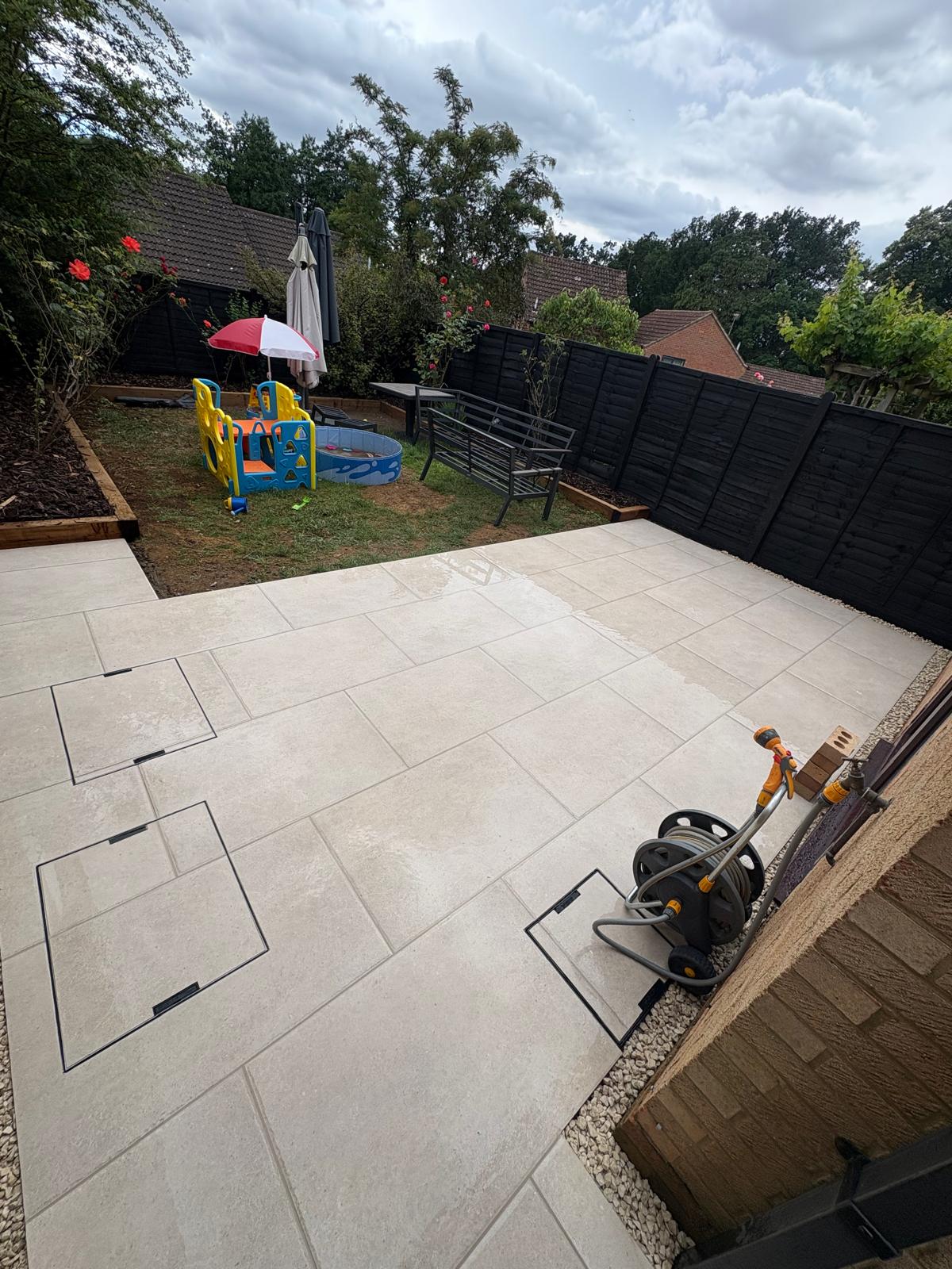 Completed light stone patio looking out over a garden