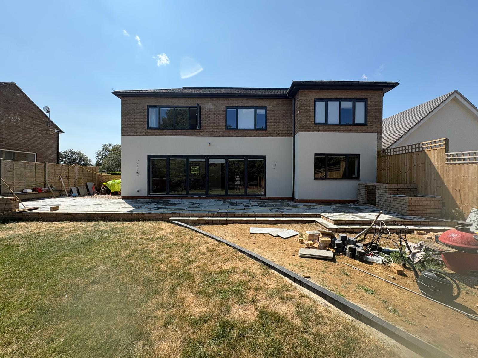 Paving and ground preparation at the rear of a two-storey home